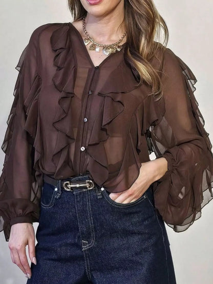Ruffled sheer long sleeve blouse by Trendsi featuring delicate ruffles and lightweight fabric, perfect for elegant, feminine style.
