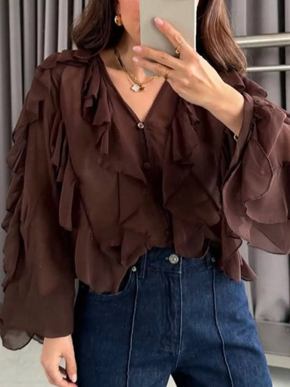Sheer long sleeve blouse with ruffled details in white from Trendsi, featuring a delicate, feminine design.