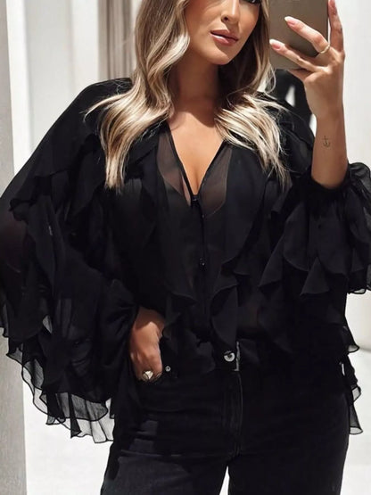 Sheer long sleeve blouse with ruffled accents, lightweight fabric, and feminine design by Trendsi.