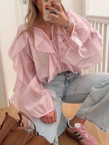 Sheer long sleeve blouse with ruffled details from Trendsi, featuring a lightweight, elegant design perfect for stylish outfits.