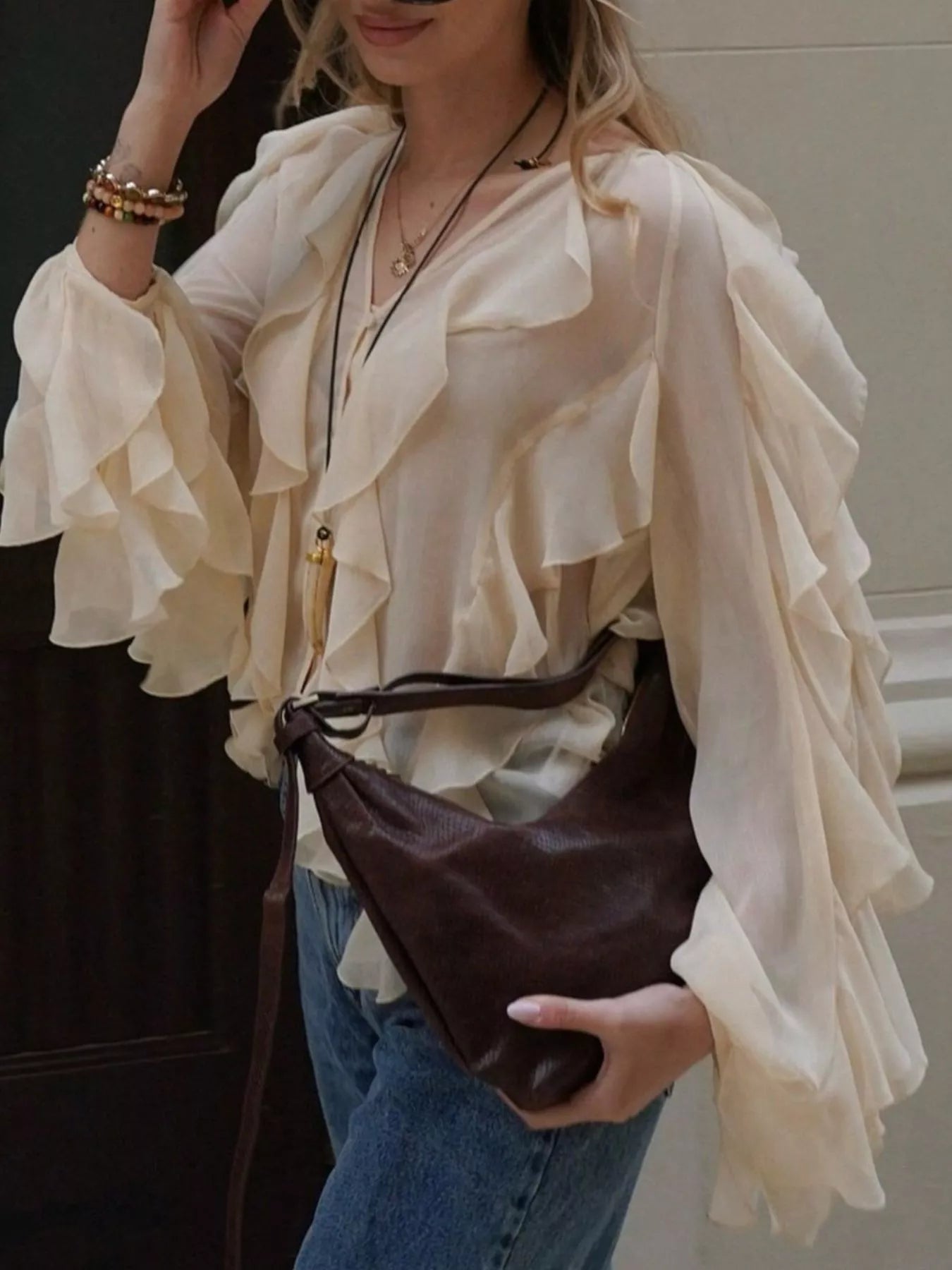 Brown ruffled sheer long sleeve blouse from Trendsi, featuring delicate ruffles and lightweight, transparent fabric.
