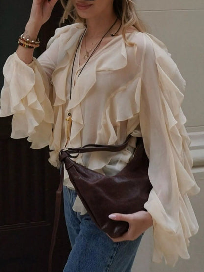Brown ruffled sheer long sleeve blouse from Trendsi, featuring delicate ruffles and lightweight, transparent fabric.