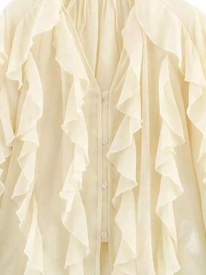Ruffled sheer long sleeve blouse from Trendsi featuring delicate ruffles and lightweight fabric, stylish and feminine.