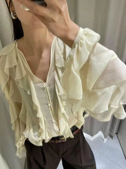 Brown ruffled sheer long sleeve blouse by Trendsi featuring delicate ruffle details and a lightweight, transparent fabric.