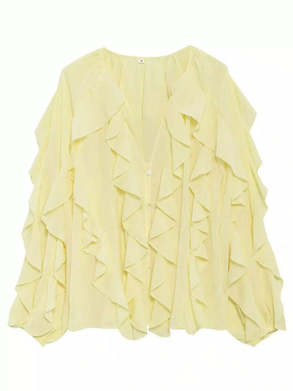 Brown ruffled sheer long sleeve blouse from Trendsi, featuring delicate ruffle details and lightweight, transparent fabric.