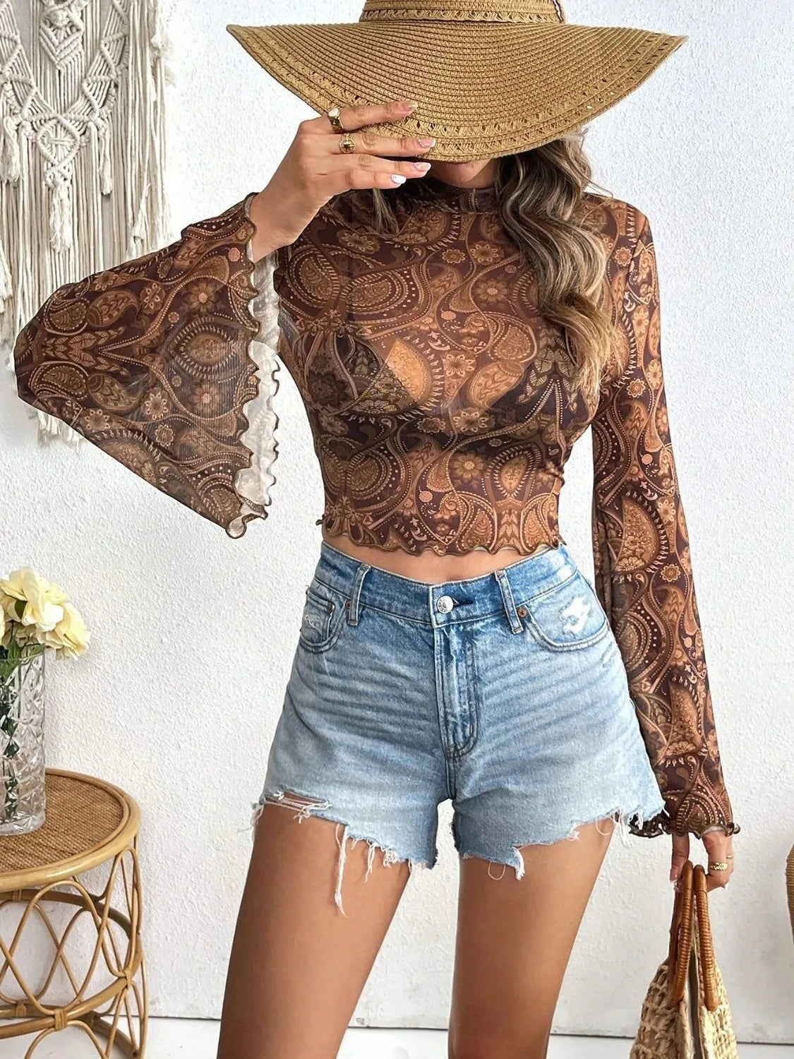 Printed camel-colored mock neck long sleeve cropped T-shirt by Trendsi, featuring a stylish printed design and fitted silhouette.
