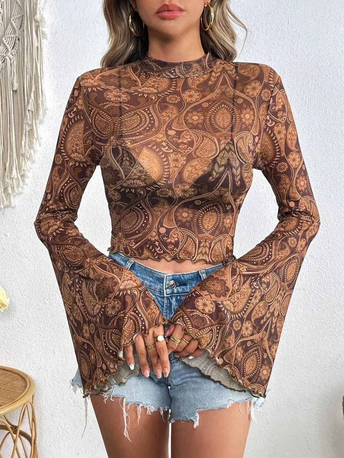 Printed camel-colored mock neck long sleeve cropped T-shirt by Trendsi, featuring a stylish pattern and fitted design.