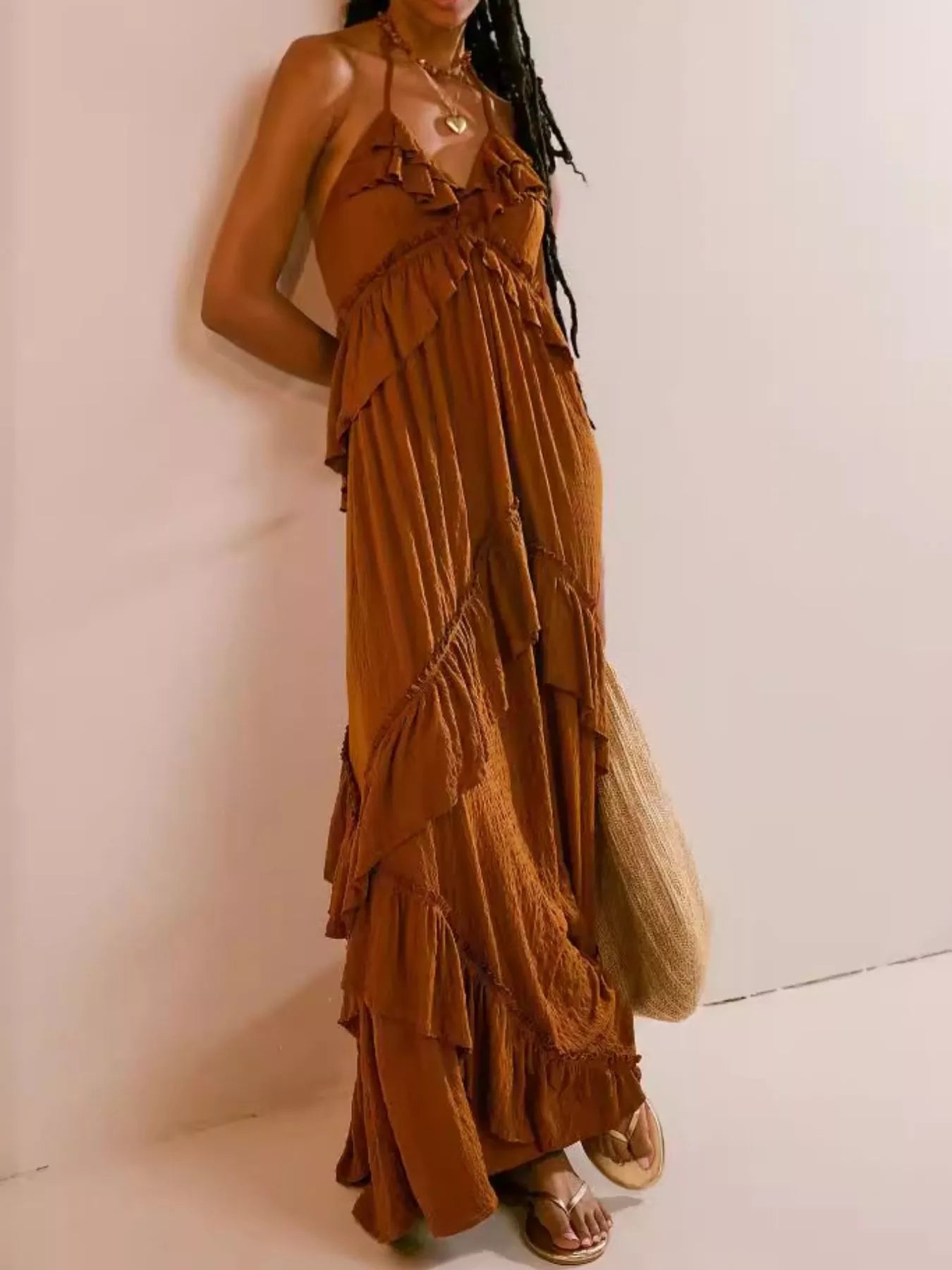 Ruffled halter neck maxi dress by Trendsi, featuring flowing fabric and elegant ruffle details in a stylish, full-length design.