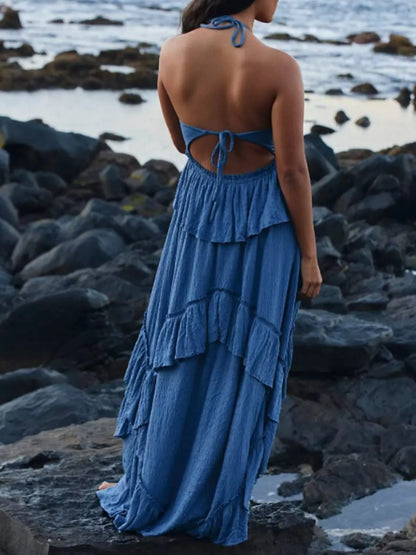 Ruffled halter neck maxi dress by Trendsi featuring flowing fabric and a stylish ruffled design for elegant summer wear.