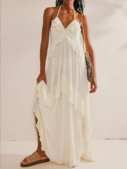 Ruffled halter neck maxi dress with flowing fabric and floral pattern, perfect for summer occasions.