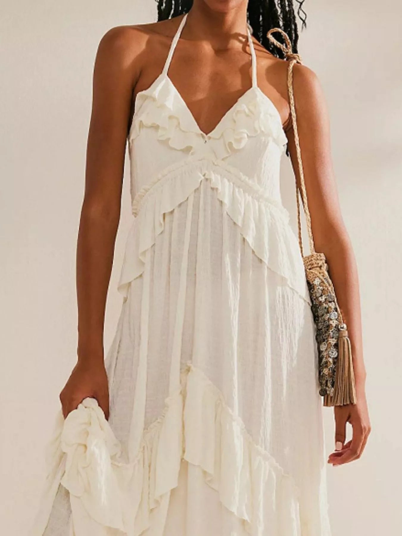 Ruffled halter neck maxi dress by Trendsi featuring flowing fabric and ruffle details in a stylish, elegant design.