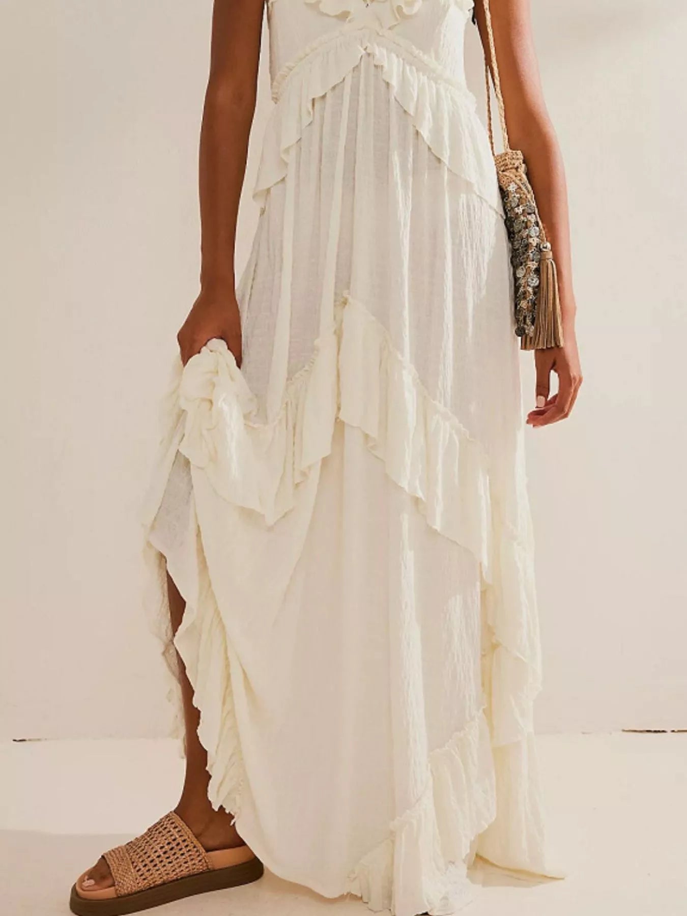 Ruffled halter neck maxi dress by Trendsi featuring flowing fabric and a stylish ruffled neckline.