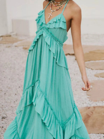 Ruffled halter neck maxi dress by Trendsi featuring flowing fabric and a stylish ruffled design.