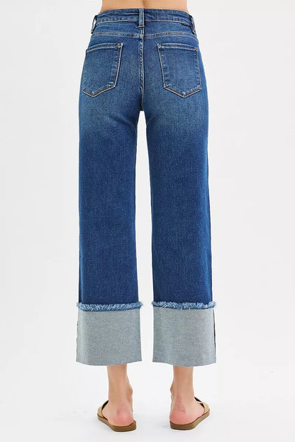 Plus size dark wash Risen mid-rise crop wide cuff jeans from Trendsi, showcasing relaxed fit and stylish wide cuffs.