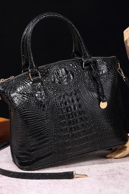 Black PU leather handbag with silver hardware, trendy design, and structured shape, perfect for casual or formal wear.