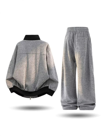 Plus size men's thick jacket and pants tracksuit set by Trendsi, featuring a cozy, casual athletic wear look in black.