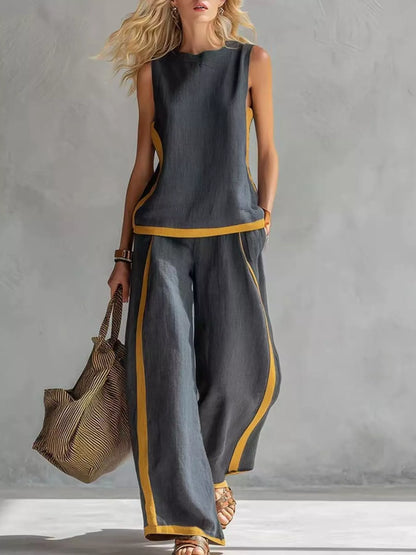 Plus size contrast stripe sleeveless top and wide-leg pants set by Trendsi, featuring bold stripes and a comfortable fit.