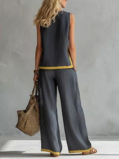 Plus size contrast stripe sleeveless top and wide-leg pants set by Trendsi, featuring bold stripe details and comfortable fit.