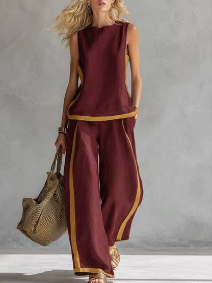 Plus size contrast stripe sleeveless top and wide-leg pants set by Trendsi, featuring bold stripes and comfortable fit.