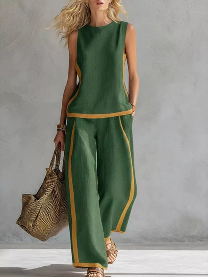 Plus size contrast stripe sleeveless top and wide-leg pants set by Trendsi, featuring bold stripes and comfortable fit.