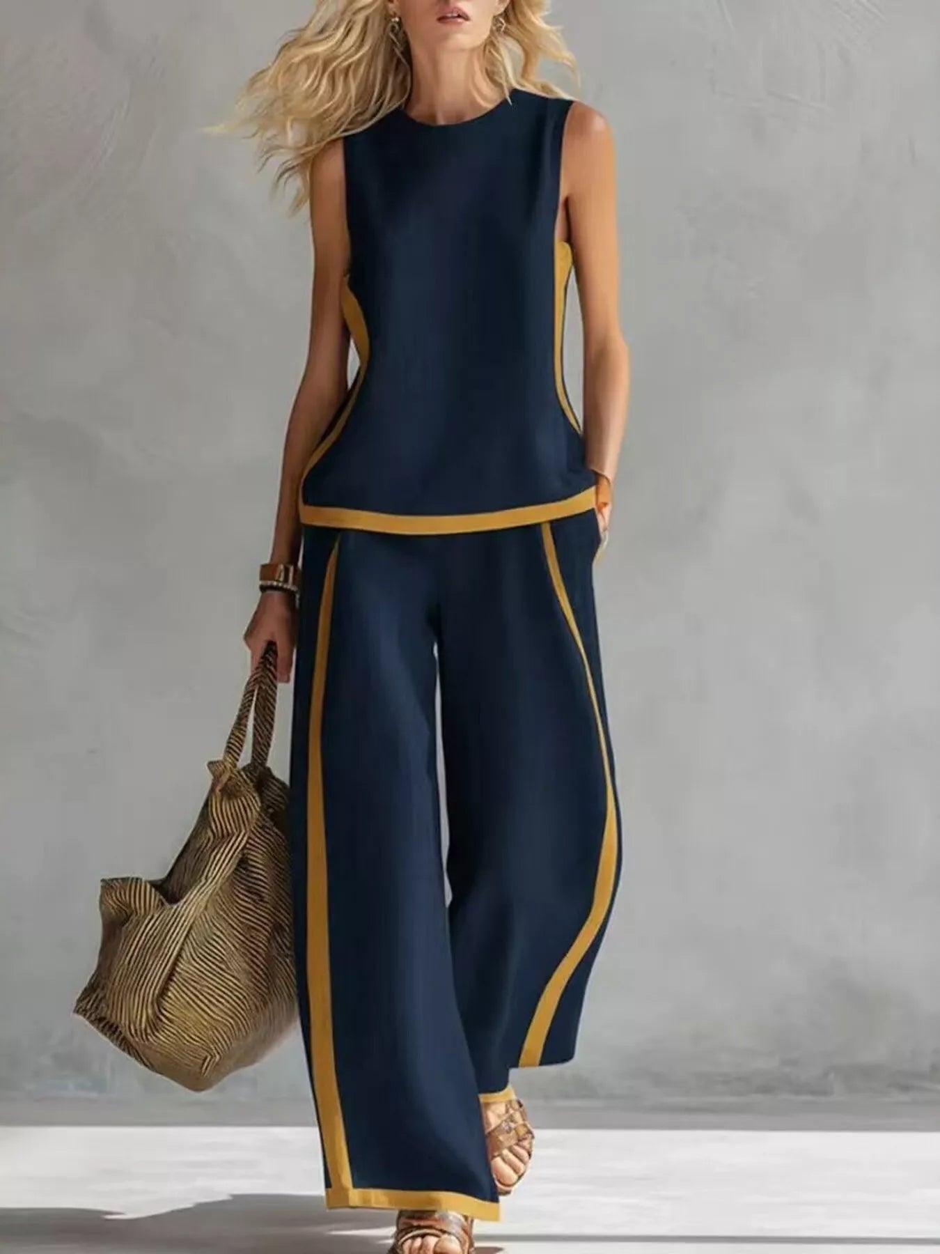 Plus size contrast stripe sleeveless top and wide-leg pants set by Trendsi, featuring bold horizontal stripes and a relaxed fit.