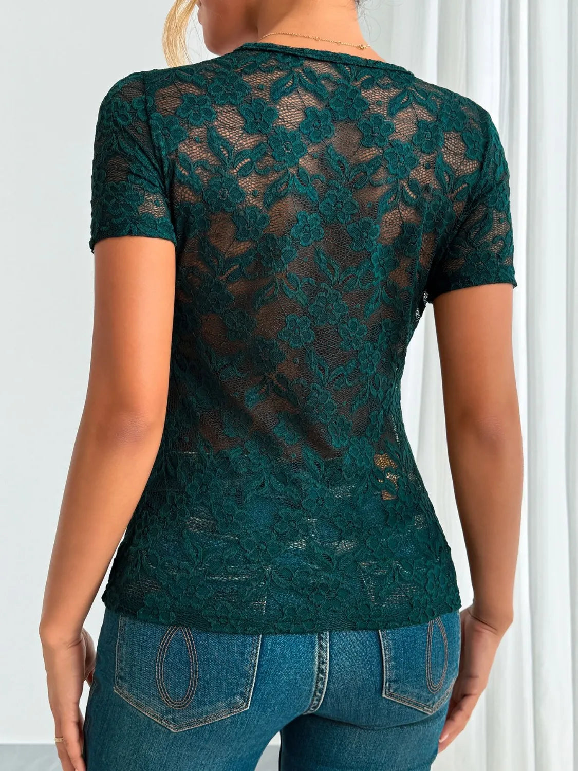 Dark green lace V-neck short sleeve top from Trendsi, featuring delicate lace fabric and a stylish V-neck design.