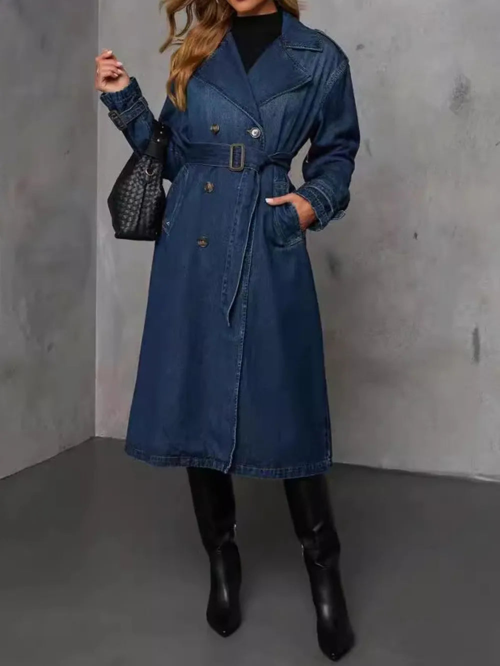 Dark wash Trendsi button-up long sleeve longline denim jacket displayed on a mannequin with front pockets and classic collar.
