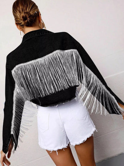 Black cropped denim jacket with fringe details and button-up front by Trendsi, styled for a casual, trendy look.