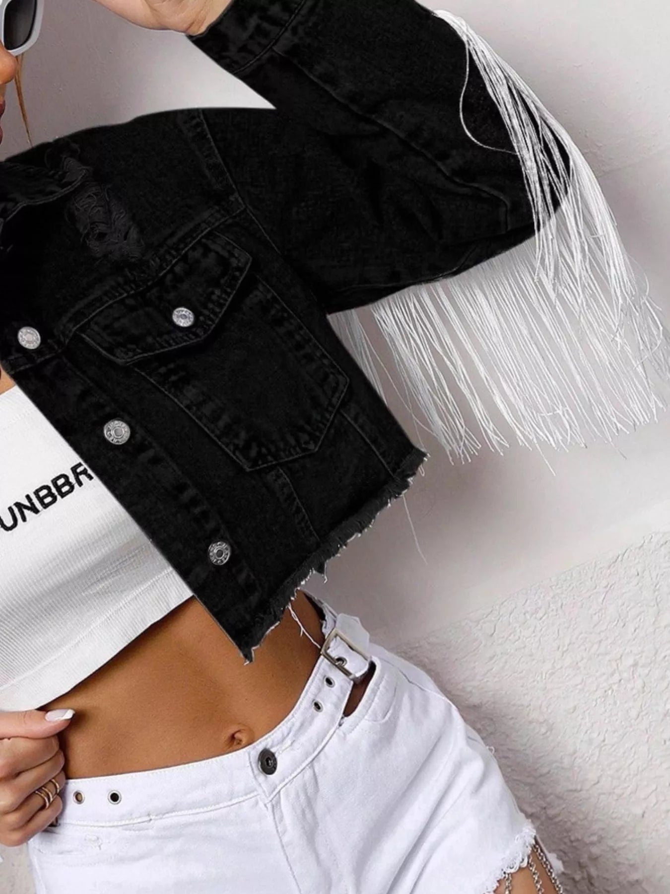 Black cropped denim jacket with fringe details and button-up front, from Trendsi, styled with long sleeves and a fitted silhouette.