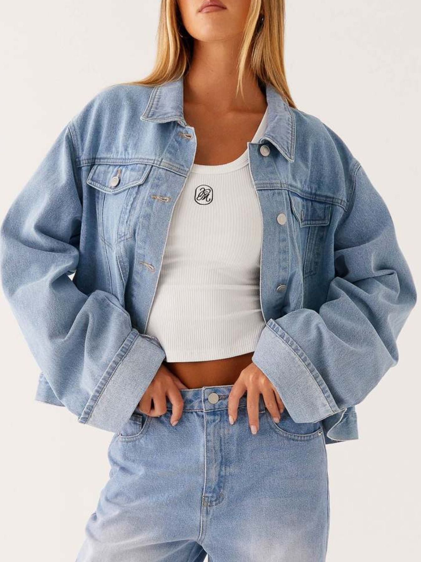Dark blue oversized denim jacket with button-down front, cropped fit, from Trendsi, styled with long sleeves and classic collar.