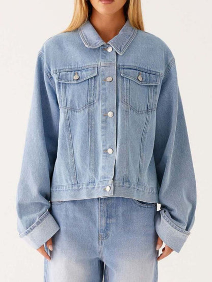 Dark blue oversized denim jacket with button-down front, cropped fit, and classic denim texture from Trendsi.