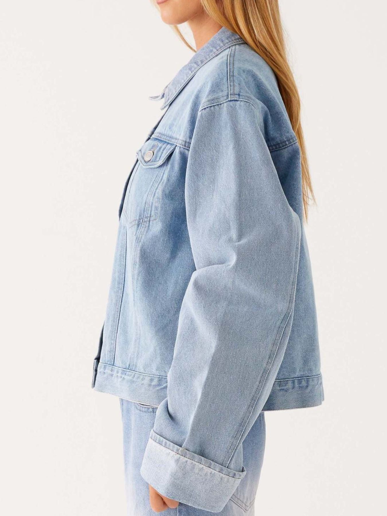 Dark blue Trendsi oversized cropped denim jacket with button-down front, long sleeves, and classic denim styling.