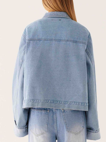 Dark blue oversized denim jacket with button-down front and cropped length, stylish Trendsi denim outerwear.