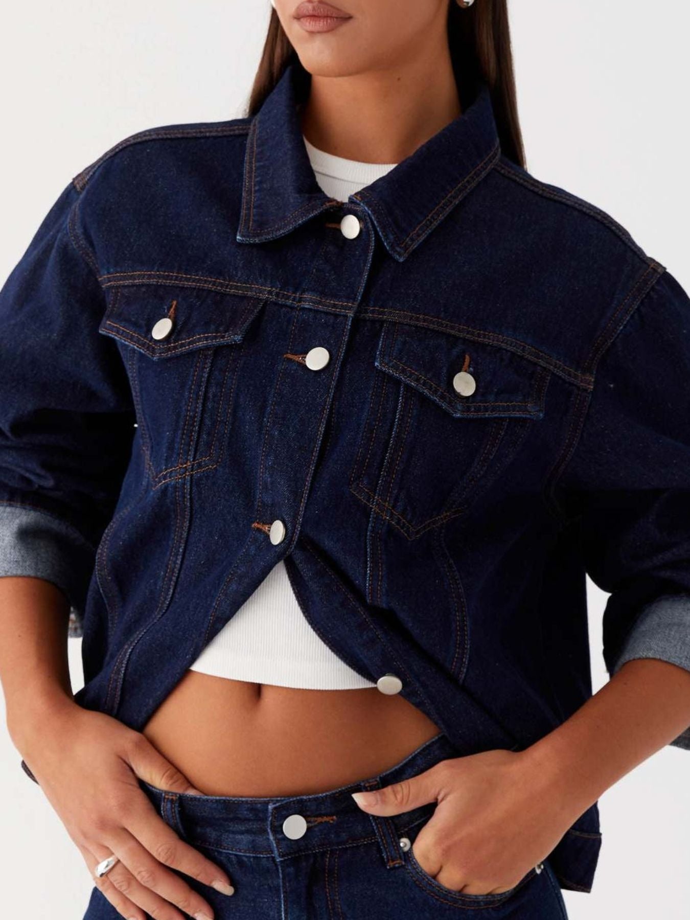 Dark blue oversized denim jacket with button-down front, cropped style, from Trendsi, styled with long sleeves and classic denim details.