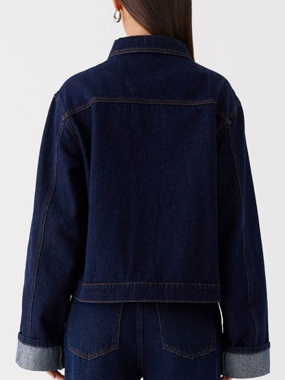 Dark blue Trendsi oversized cropped denim jacket with button-down front and relaxed fit, styled on a model.