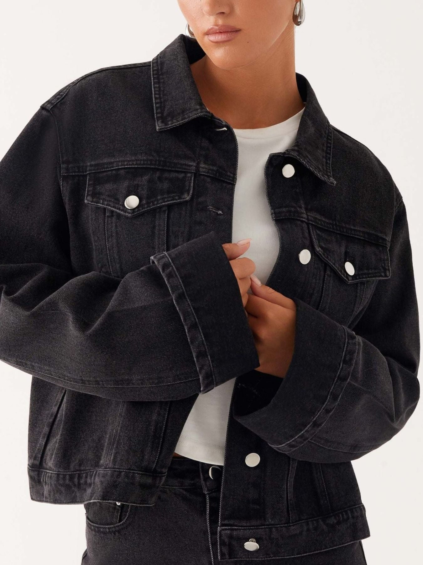 Dark blue oversized denim jacket with button-down front, cropped fit, stylish Trendsi denim jacket shown on model.