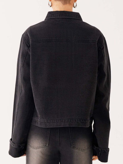 Dark blue oversized denim jacket with button-down front, cropped fit, and classic denim texture from Trendsi.