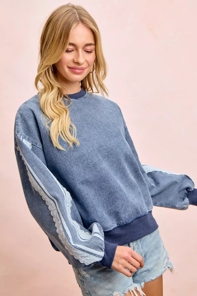 BiBi Washed Denim Lace Contrast Sided Sweatshirt from Trendsi with distressed denim fabric and lace detail on the sides.