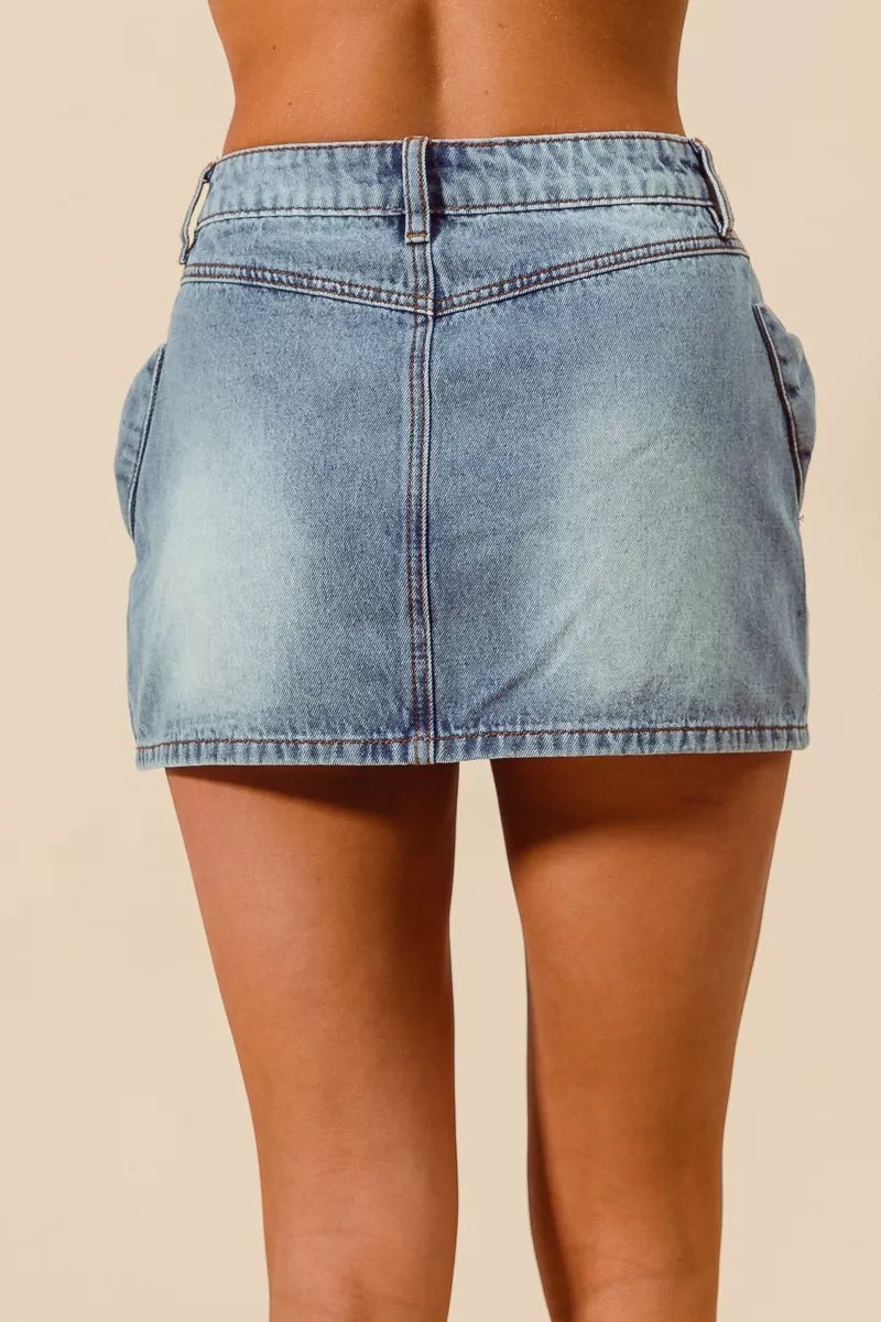 Trendsi SO ME bow knot pocket denim mini skirt featuring a stylish A-line design and front pockets.