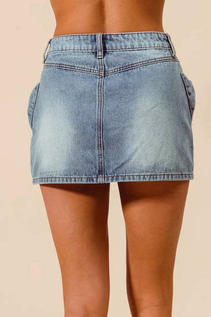 Trendsi SO ME bow knot pocket denim mini skirt featuring a stylish A-line design and front pockets.