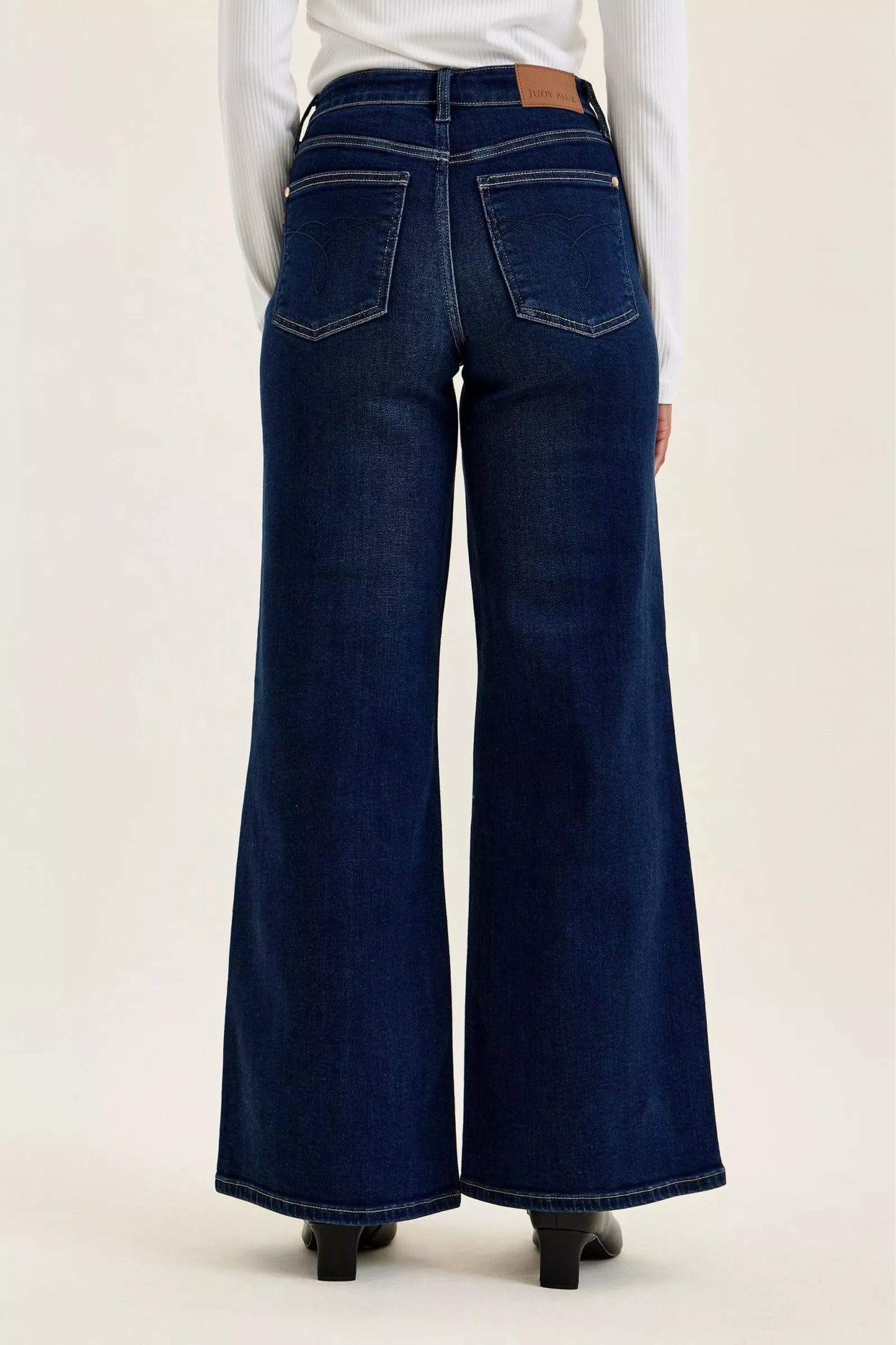 Dark wash Judy Blue high-waisted wide-leg jeans with classic fit and subtle fading, styled for a trendy casual look.