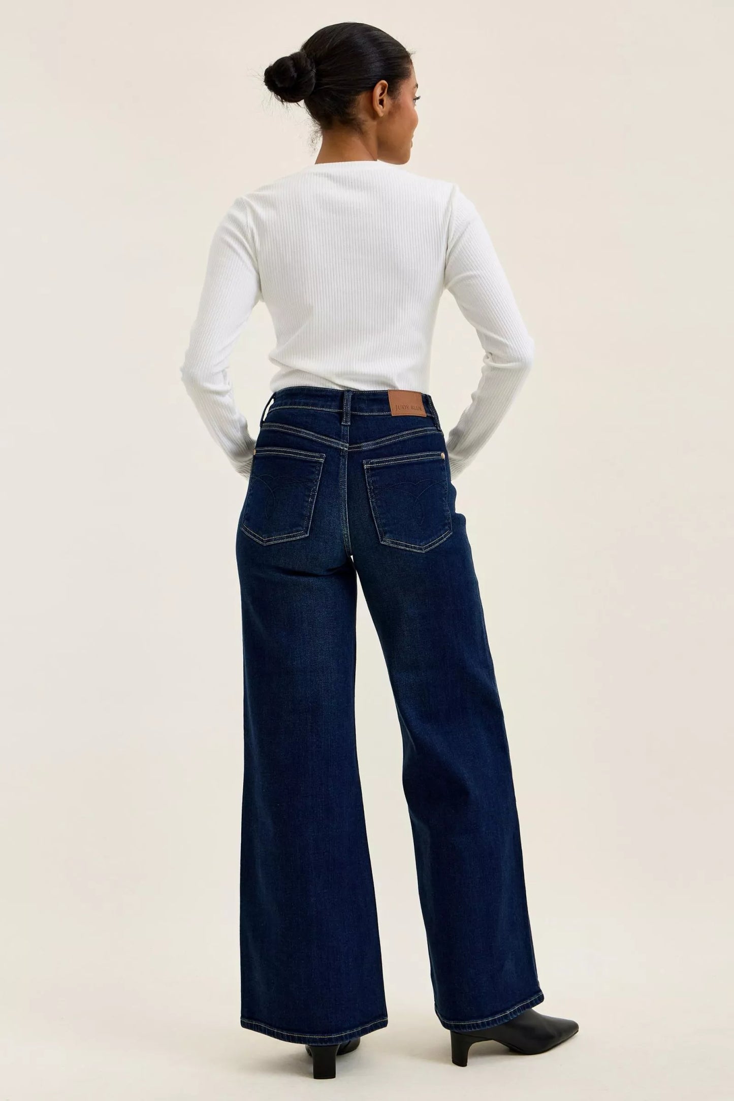 Dark wash Judy Blue high-waisted wide-leg jeans with classic fit and stylish design, displayed on a neutral background.
