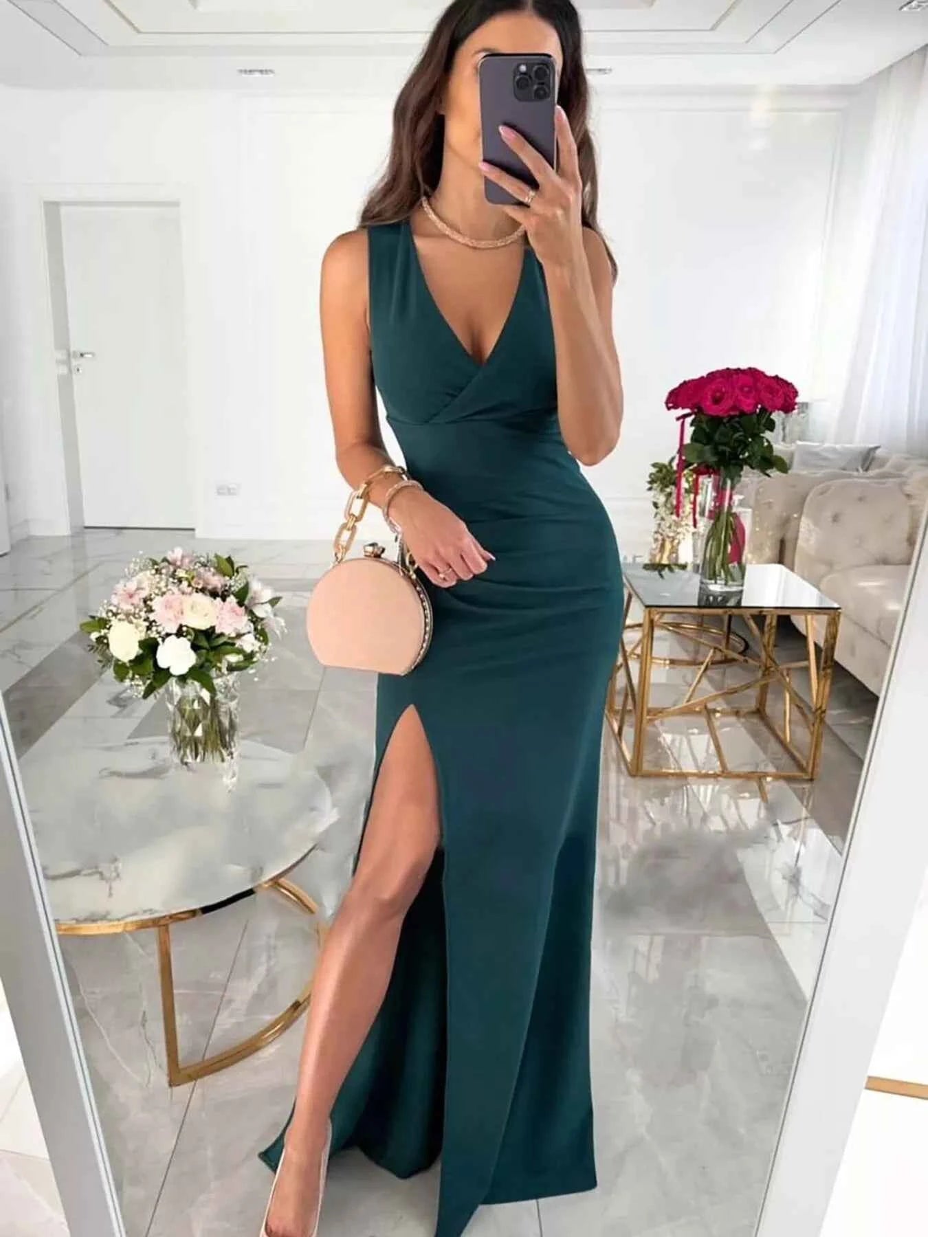 Dust Storm Effortlessly Chic sleeveless high slit maxi dress by Trendsi, flowing fabric, suitable for casual or formal occasions.
