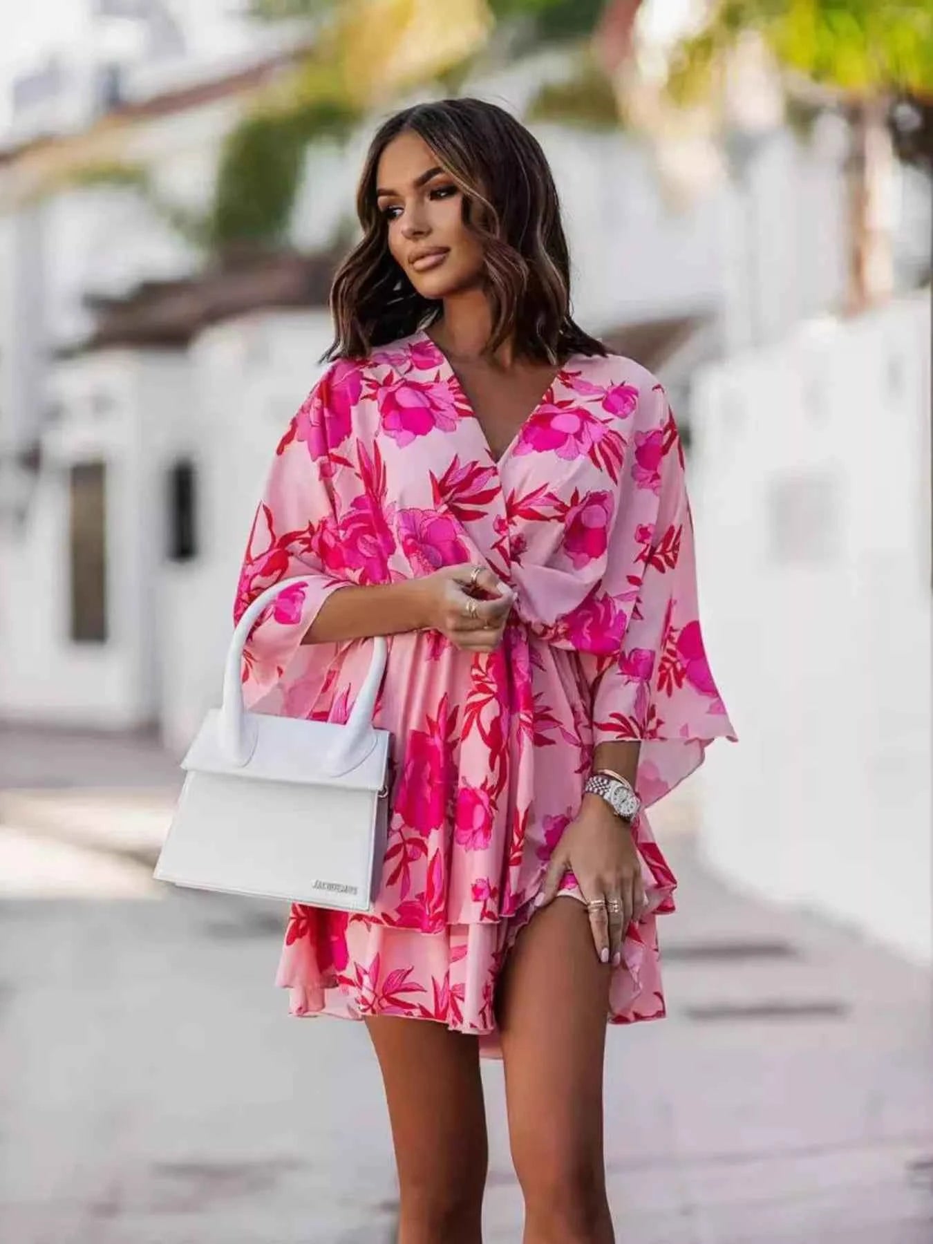 Orange layered printed surplice mini dress by Trendsi featuring a chic, effortless style with a flattering silhouette.