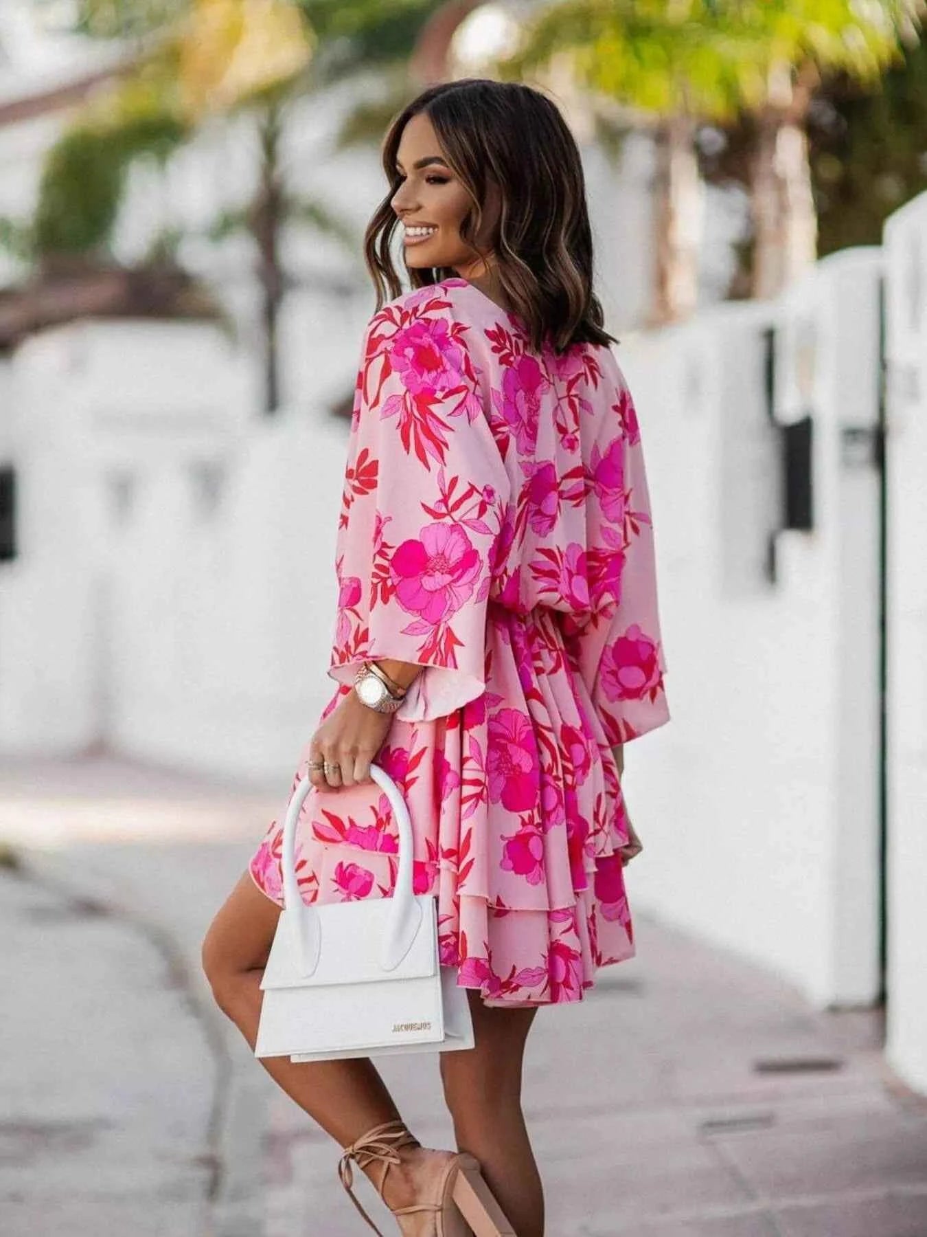 Orange printed layered surplice mini dress from Trendsi, featuring a chic design and effortless style, perfect for casual or dressy occasions.