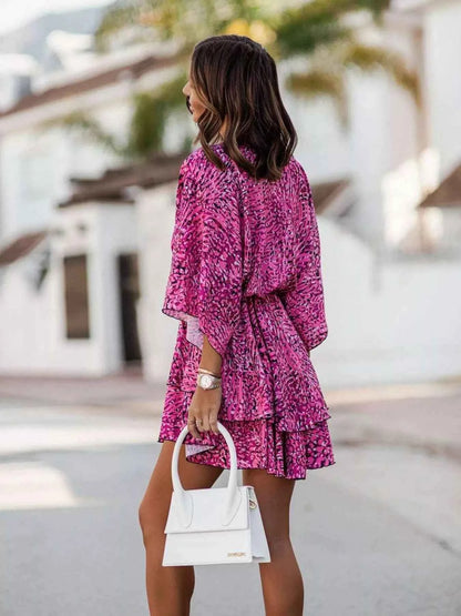 Orange Chic Layered Printed Surplice Mini Dress by Trendsi, featuring a stylish layered design and feminine print in a mini length.