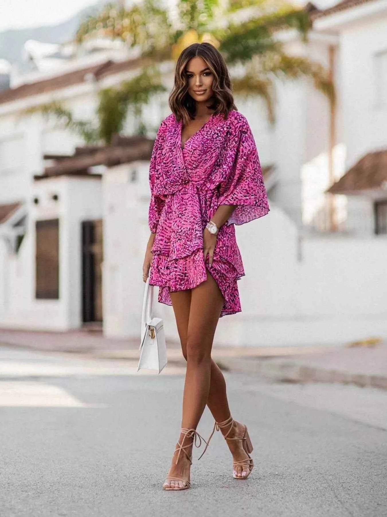 Orange Chic Layered Printed Surplice Mini Dress from Trendsi, featuring a stylish layered design and flattering surplice neckline.