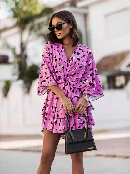 Orange layered printed surplice mini dress from Trendsi, featuring a chic, effortless style with a flattering silhouette.