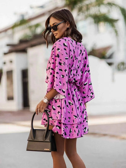 Orange Chic Layered Printed Surplice Mini Dress from Trendsi, featuring a stylish design and effortless fit for trendy occasions.