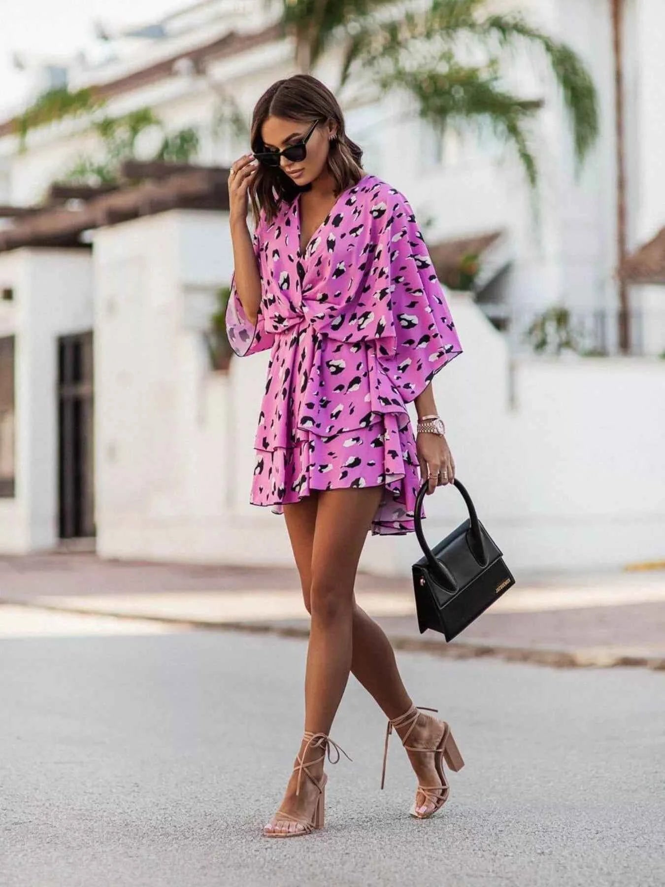 Orange chic layered printed surplice mini dress from Trendsi, featuring a stylish design and effortless fashion appeal.